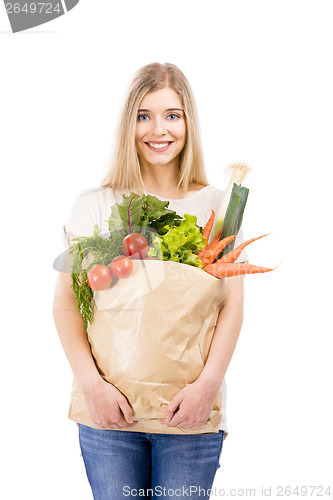 Image of Beautiful woman carrying vegetables