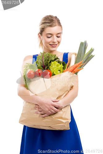 Image of Beautiful woman carrying vegetables