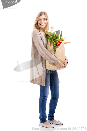 Image of Beautiful woman carrying vegetables