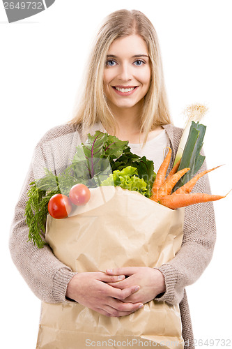 Image of Beautiful woman carrying vegetables