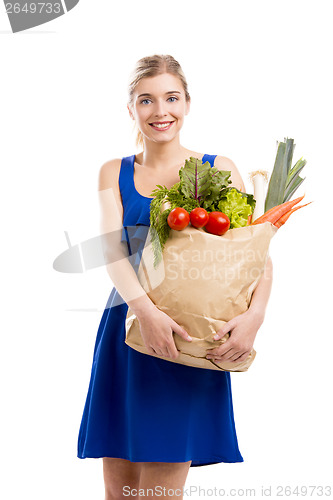 Image of Beautiful woman carrying vegetables