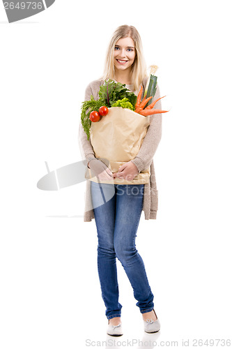 Image of Beautiful woman carrying vegetables