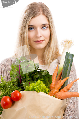 Image of Beautiful woman carrying vegetables
