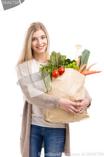 Image of Beautiful woman carrying vegetables