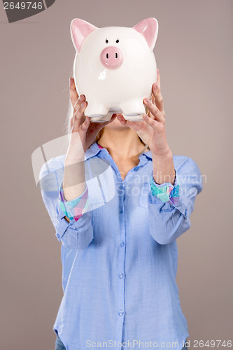 Image of Beautiful woman holding  a piggy bank