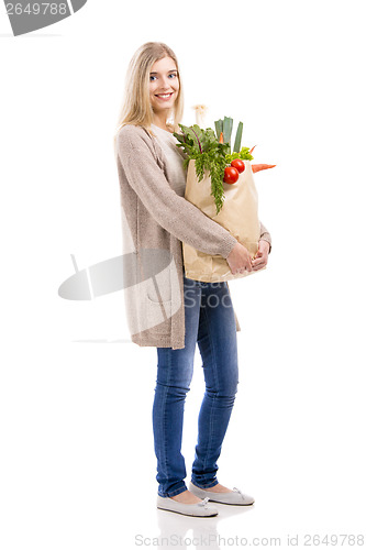 Image of Beautiful woman carrying vegetables