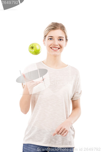 Image of Beautiful woman throwing a green apple
