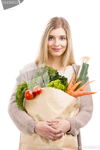 Image of Beautiful woman carrying vegetables