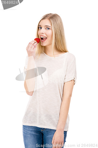 Image of Woman tasting strawberries