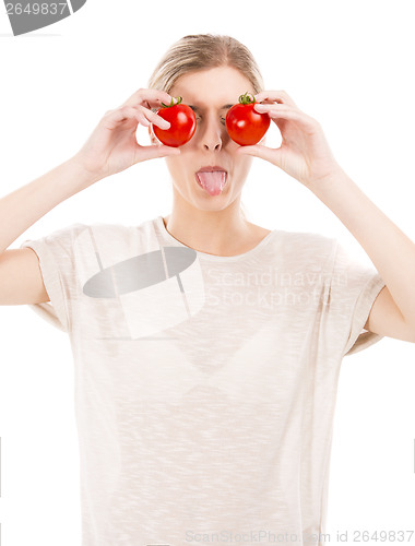 Image of Beaitiful woman with tomatos in front of the face