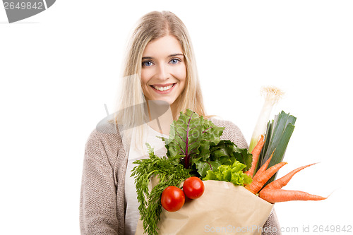 Image of Beautiful woman carrying vegetables