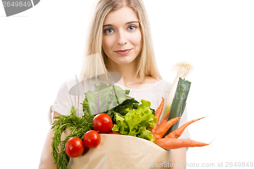 Image of Beautiful woman carrying vegetables