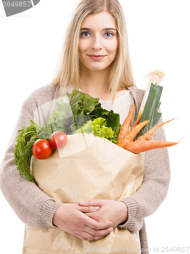 Image of Beautiful woman carrying vegetables