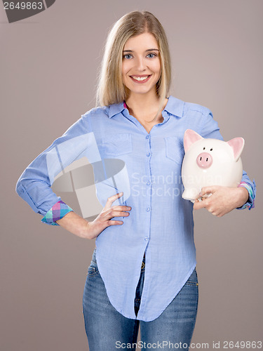 Image of Beautiful woman holding  a piggy bank