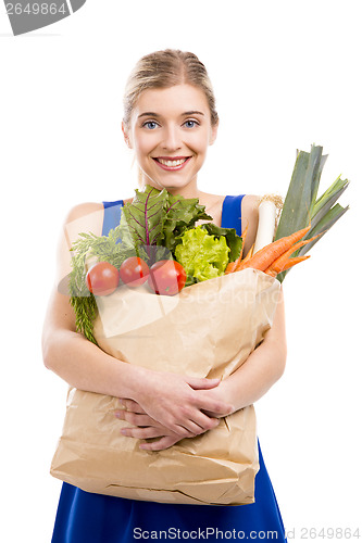 Image of Beautiful woman carrying vegetables