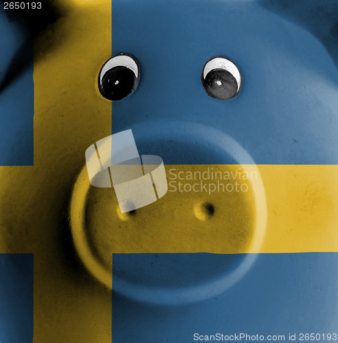 Image of Ceramic piggy bank with painting of national flag 