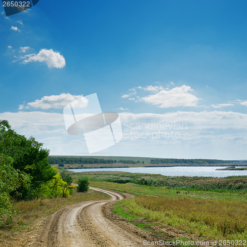 Image of winding dirty road and blue sky