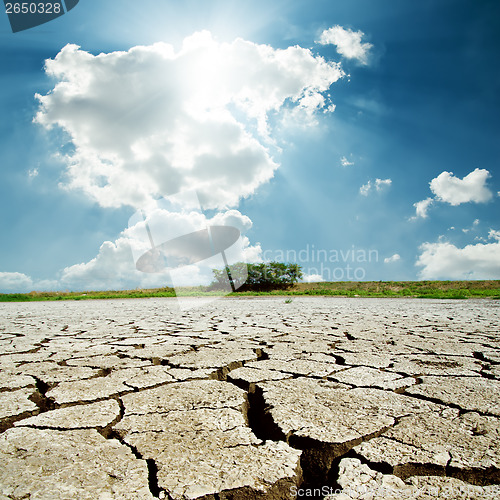 Image of drought earth and sun in cloudy sky