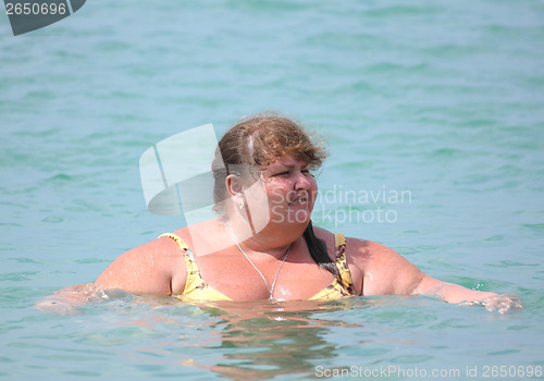 Image of plump woman bath in sea