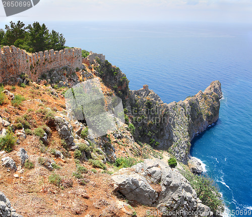 Image of rocky headland in sea and fortress wall in Alanya
