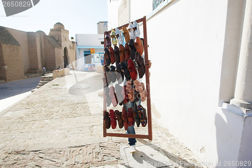 Image of Muslim man selling shoes