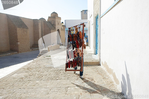 Image of A muslim man selling shoes
