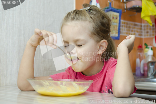 Image of Girl eating porridge in the kitchen