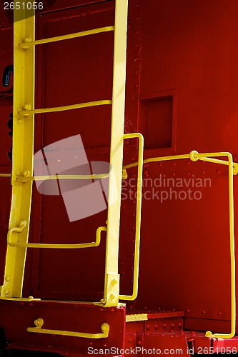 Image of yellow ladder on red caboose