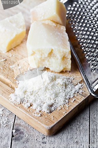 Image of grated parmesan cheese and metal grater