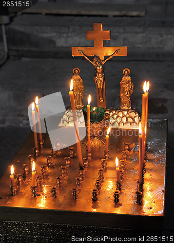 Image of candles and crucifix in church