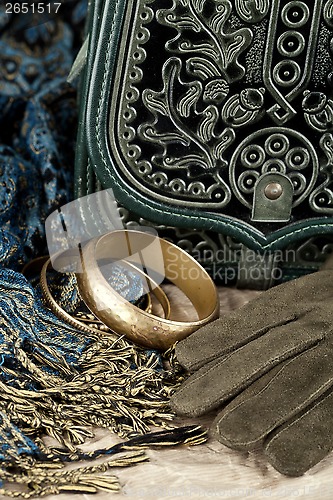 Image of vintage bag, leather gloves, bracelets and scarf 