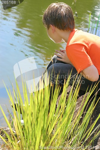 Image of Boy sitting by the lake