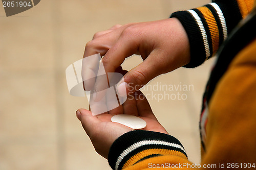 Image of Boy holding a communion bead