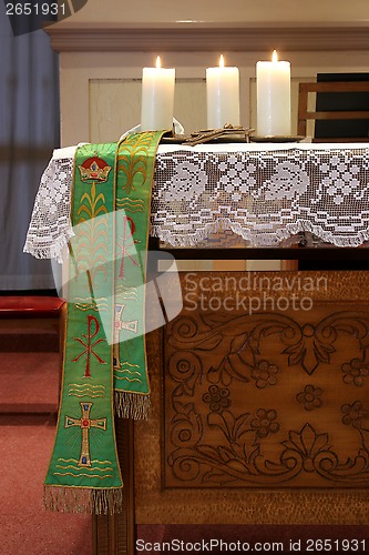 Image of Three burning candles on church altar