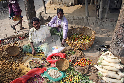 Image of Tribal villagers bargain for vegetables. Kumrokhali, West Bengal, India