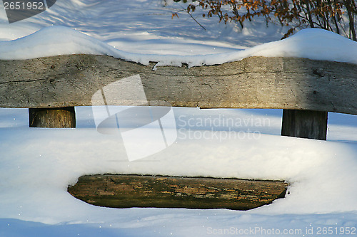 Image of Wooden bench covered with snow