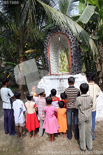 Image of Group of young Bengali Catholics pray before a statue of the Blessed Virgin Mary, Basanti, West Bengal, India