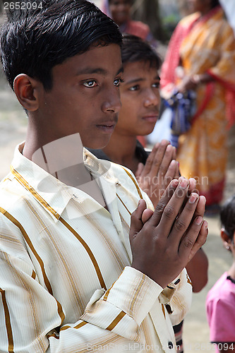 Image of Group of young Bengali Catholics pray before a statue of the Blessed Virgin Mary, Basanti, West Bengal, India