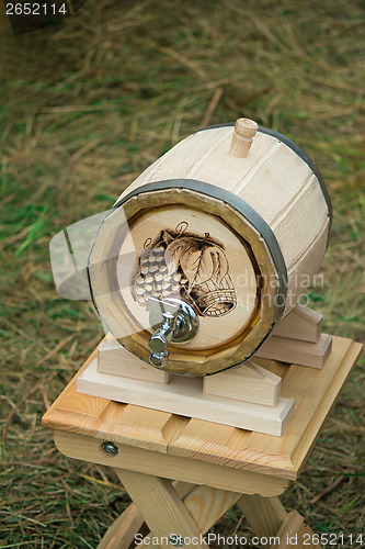 Image of Wooden oak barrel wine, beer with metal crane. Sold at the fair.