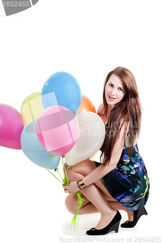 Image of Beautiful female keeping multicolored air balloons