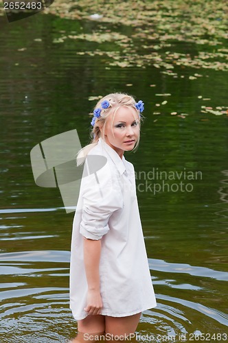 Image of Woman standing in the water looking back