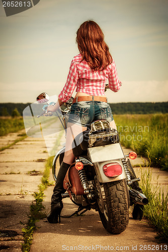 Image of Biker girl and motorcycle