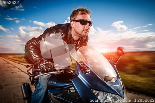 Image of Biker racing on the road