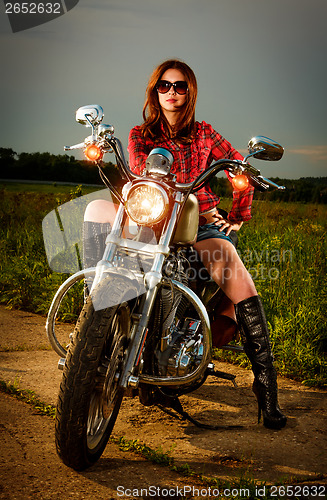 Image of Biker girl and motorcycle