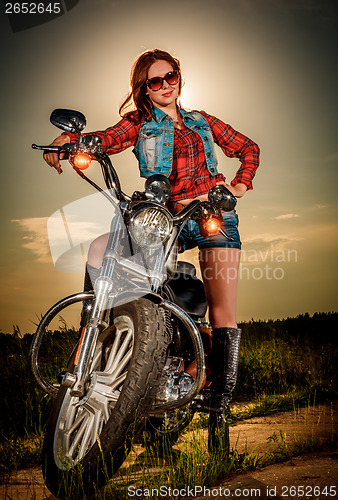 Image of Biker girl and motorcycle