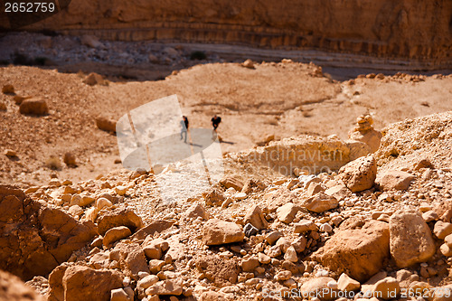 Image of Tourists hiking in dead sea mountains