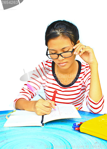 Image of young girl  homework on the table