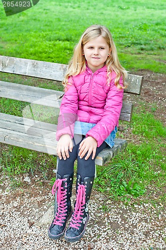 Image of girl sitting on a bench in the park