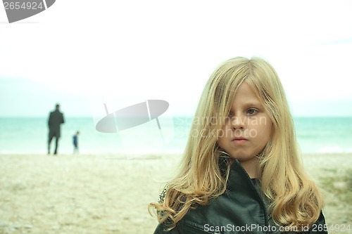 Image of unhappy young girl at the beach