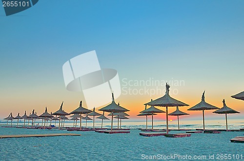 Image of wicker beach umbrellas on the beach